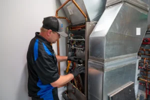 Empire State Plumbing technician servicing a home furnace and air handler