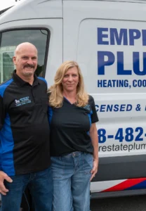 The Empire State Plumbing owners standing together in front of a branded service van at the Nassau, NY shop