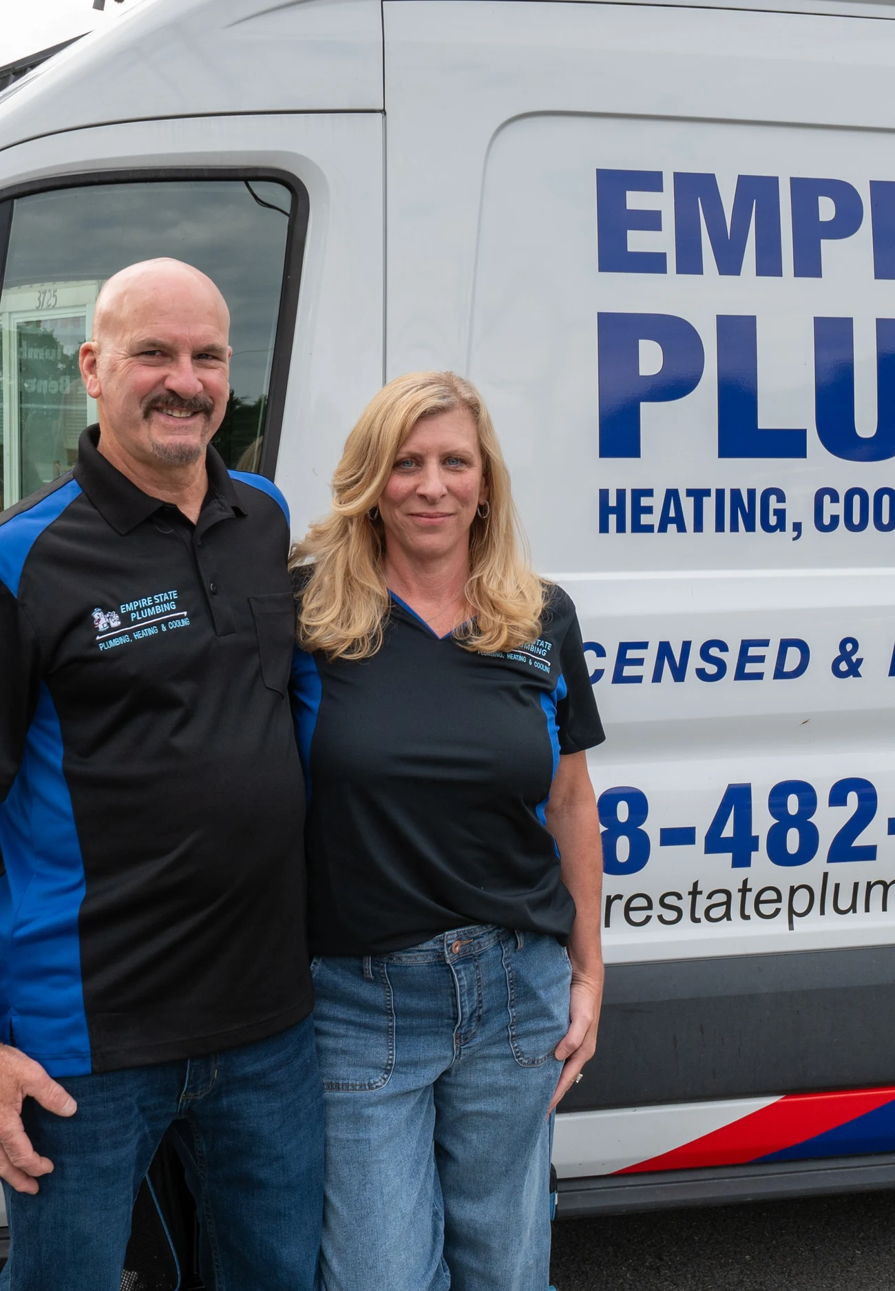 The Empire State Plumbing owners standing together in front of a branded service van at the Nassau, NY shop
