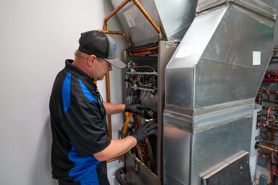Empire State Plumbing technician installing and connecting a heating and water system
