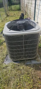 Outdoor air conditioning condenser serviced by Empire State Plumbing at a Capital Region home