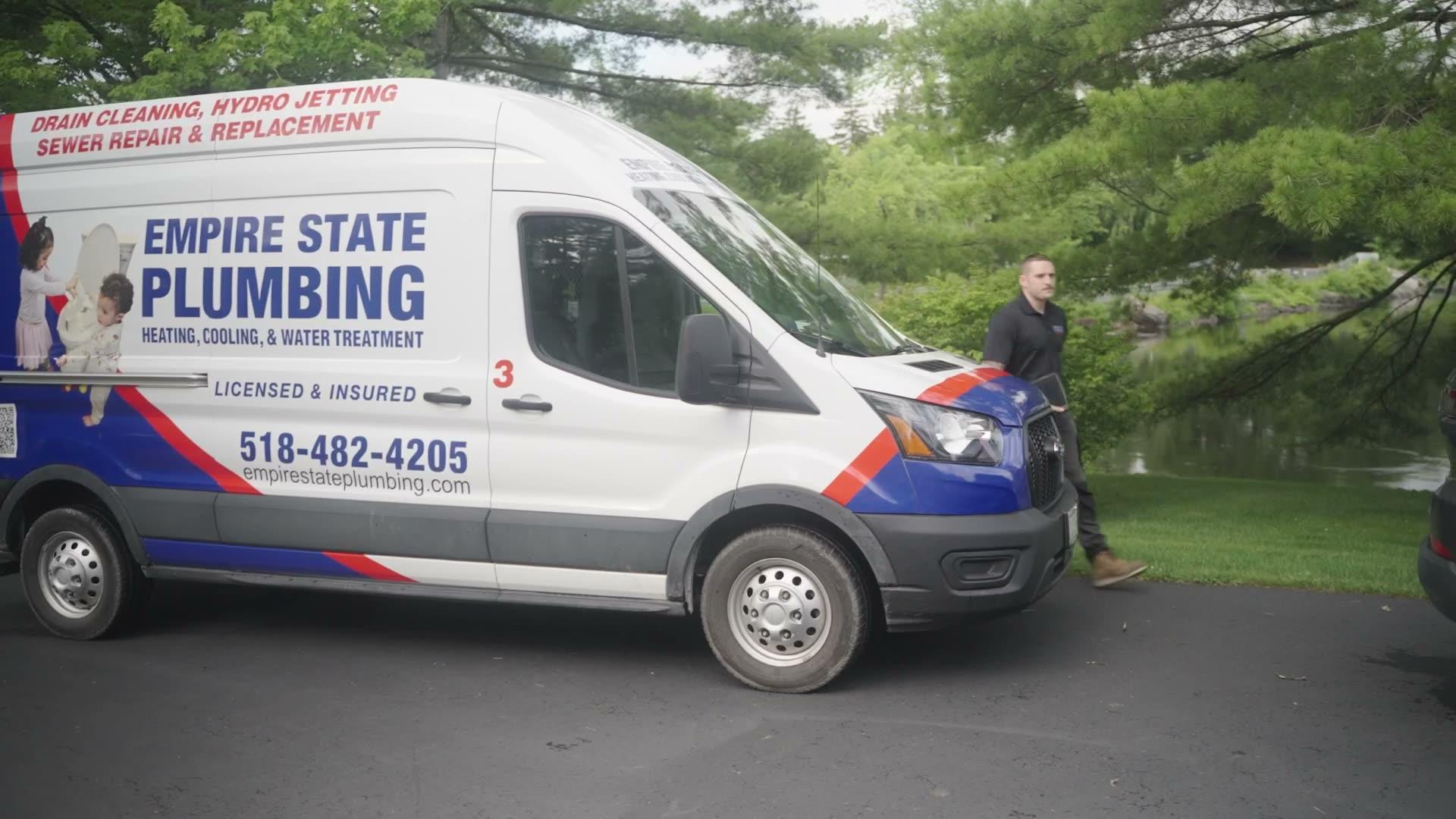 Empire State Plumbing branded service van arriving at a Capital Region home with a technician